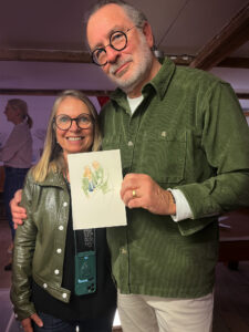 Couple holding drawings