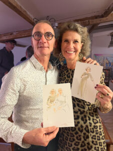 Photo of couple holding drawings